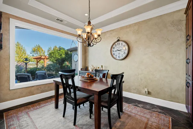 a view of a dining room with furniture wooden floor and chandelier