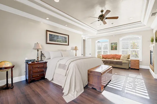 a view of swimming pool with outdoor seating and trees in the background