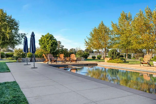 a living room with furniture a flat screen tv and a table