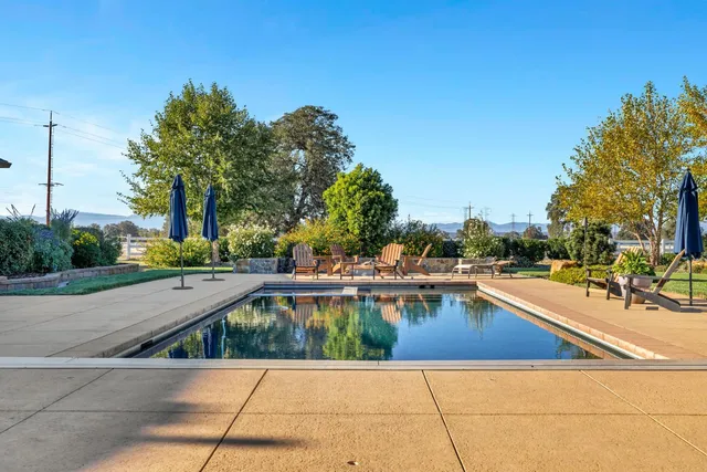 a view of a workspace with furniture and a bookshelf
