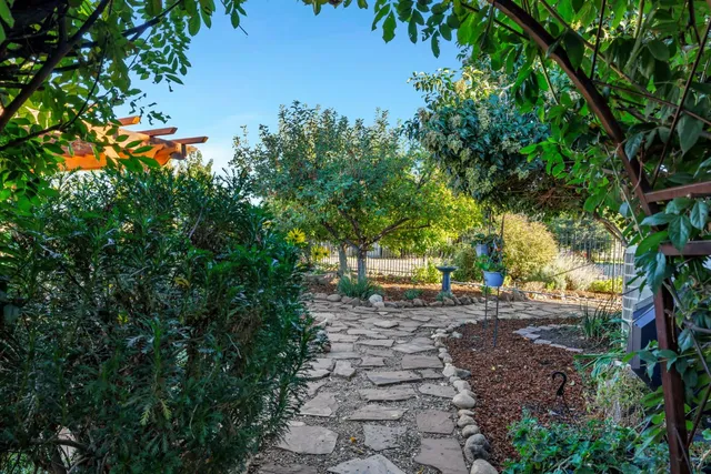 a view of a swimming pool with a patio and a yard