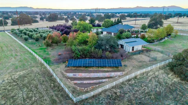 a backyard of a house with table and chairs