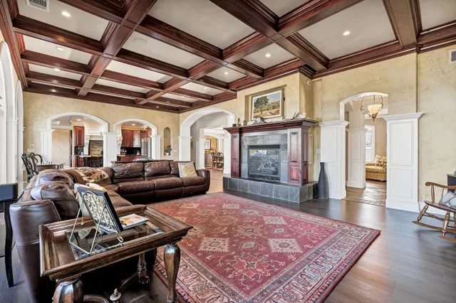 a dining hall with stainless steel appliances granite countertop a stove and a sink
