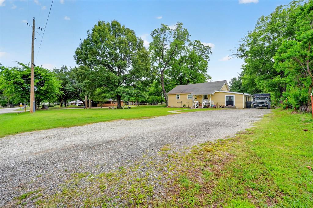 610 Crooked Creek Road Edgewood, TX 75117 - Photo 25 of 33 a view of a house with a big yard and potted plants