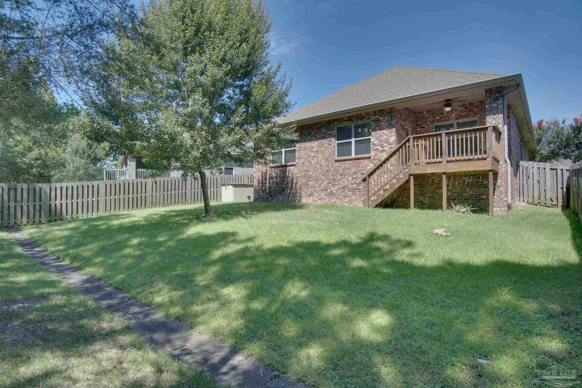 6239 Ladera Trail Pace, FL 32571 - Photo 27 of 27 a view of a house with a yard