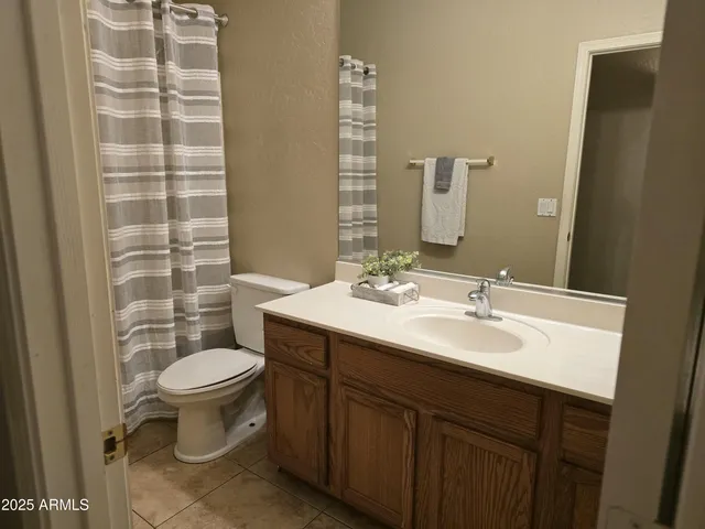 a bathroom with a sink toilet and a mirror