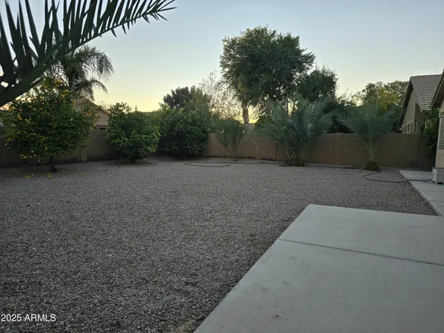 a view of a field with trees in the background