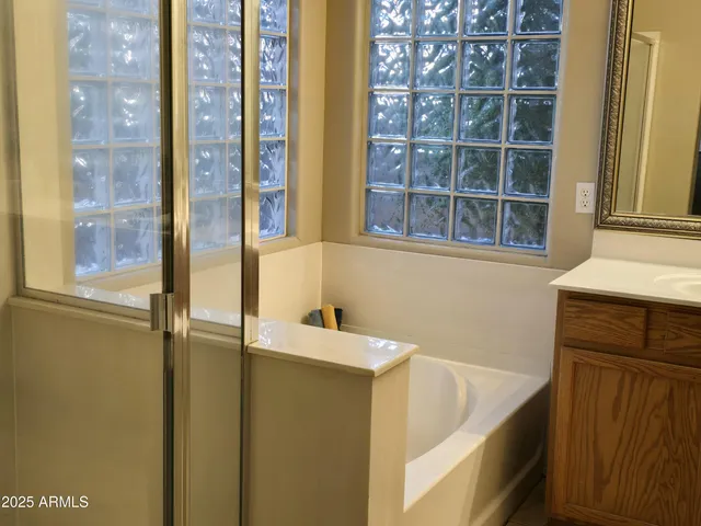 a bathroom with a tub and a sink