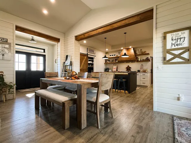 a kitchen with stainless steel appliances granite countertop wooden floors and wooden cabinets