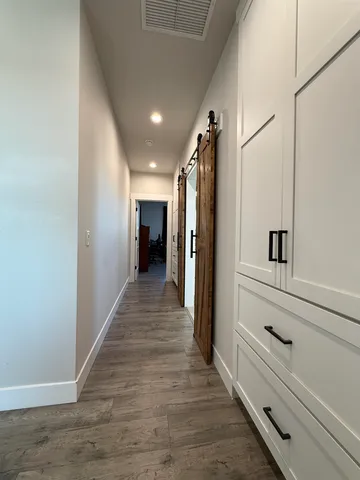 a kitchen with a refrigerator and white cabinets