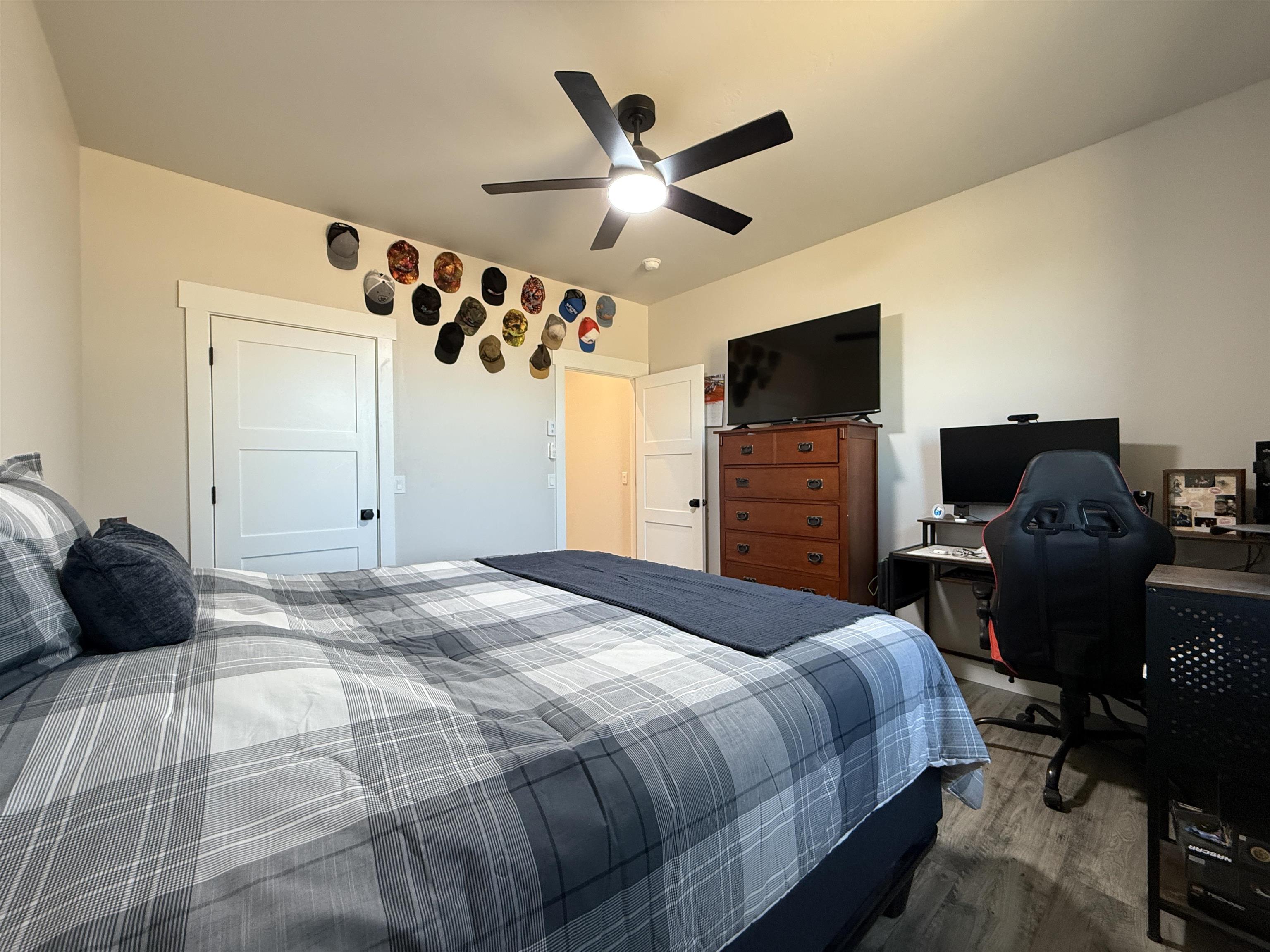 8585 Ellen's Way Austin, CO 81410 - Photo 38 of 42 a bedroom with a bed and wooden floor
