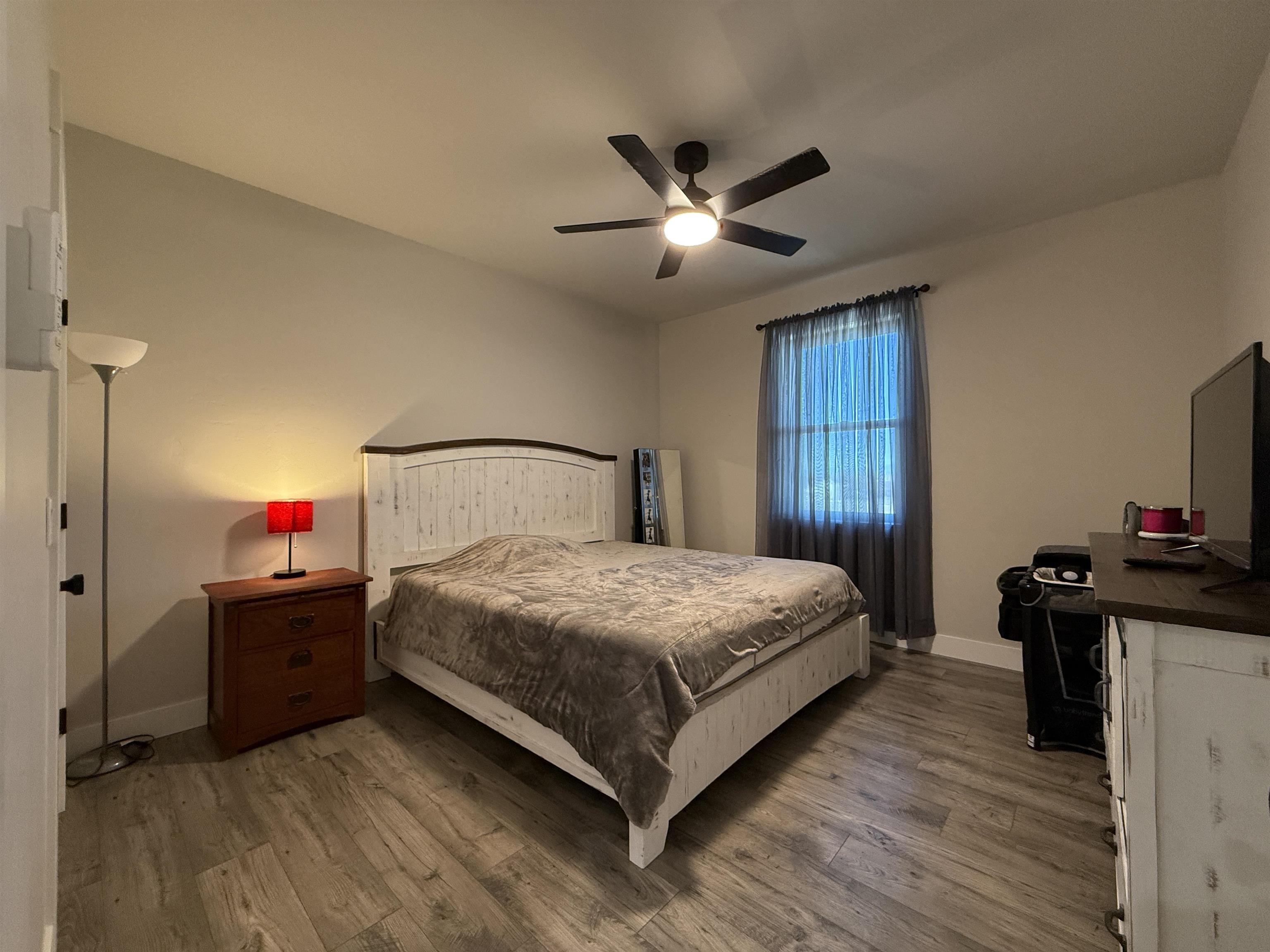 8585 Ellen's Way Austin, CO 81410 - Photo 41 of 42 a bedroom with a bed and a chandelier