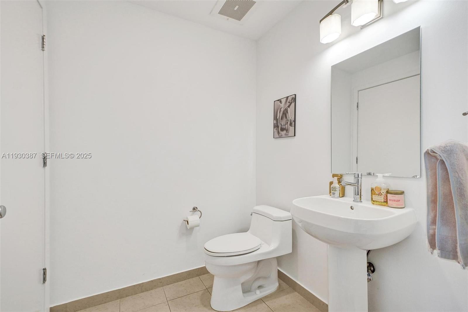 3301 Northeast 1st Avenue, Unit H1105 Miami, FL 33137 - Photo 12 of 34 a bathroom with a sink a toilet and mirror