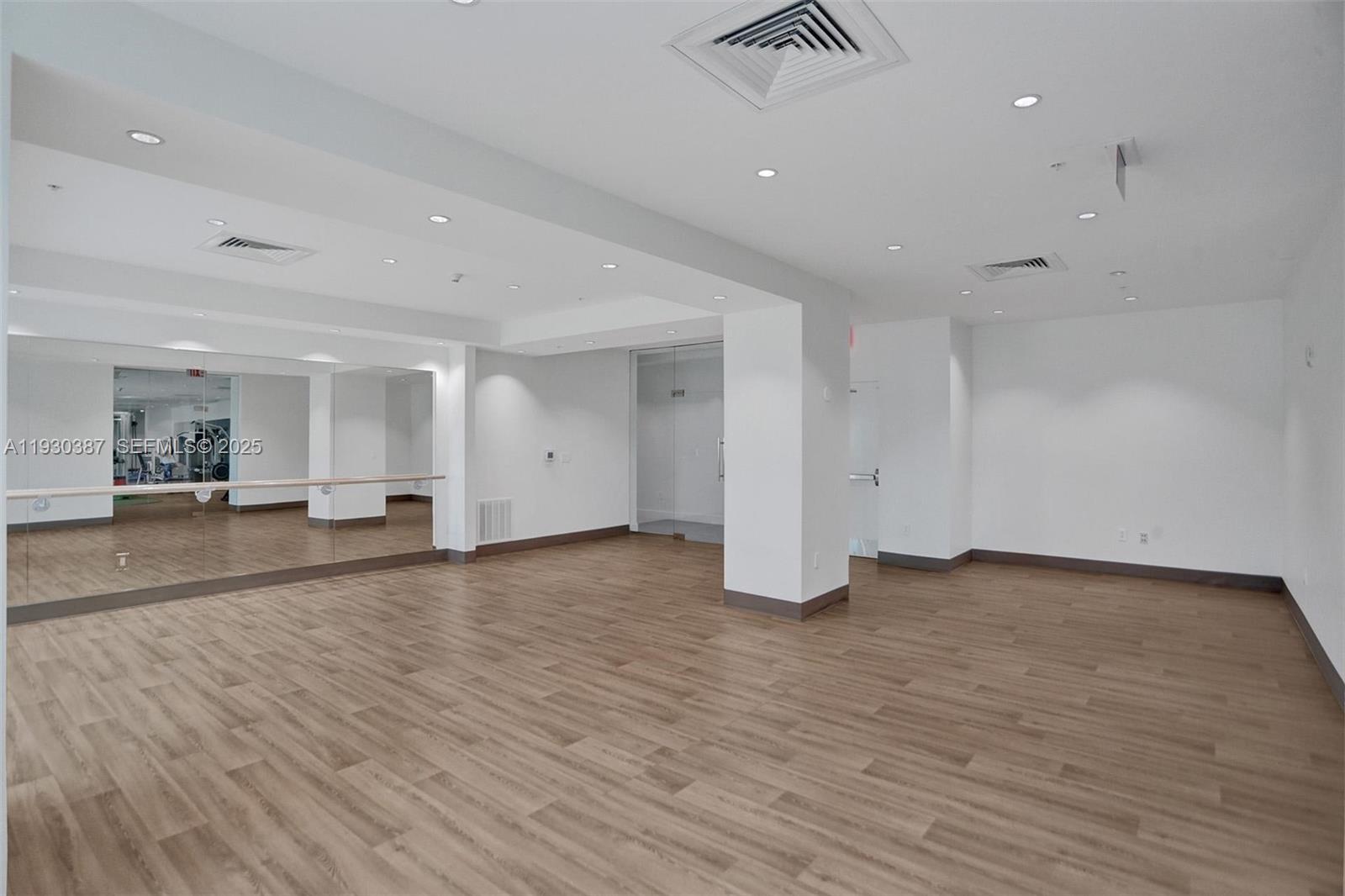 3301 Northeast 1st Avenue, Unit H1105 Miami, FL 33137 - Photo 19 of 34 a view of an empty room with wooden floor