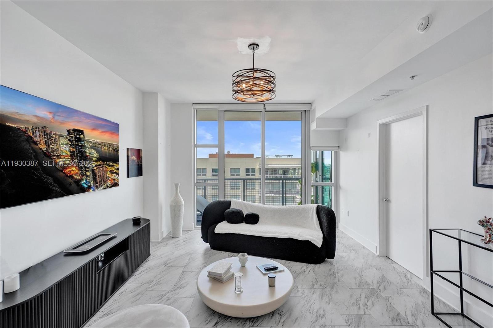 3301 Northeast 1st Avenue, Unit H1105 Miami, FL 33137 - Photo 5 of 34 a living room with furniture and a flat screen tv