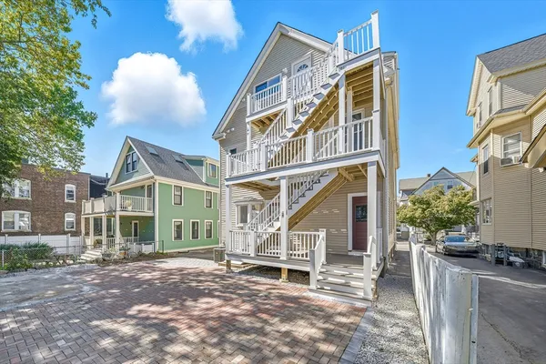 a view of a house with a patio and a yard