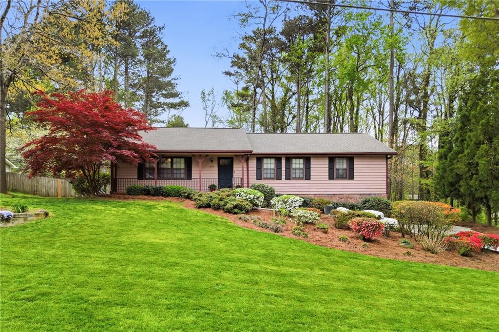 a front view of a house with a garden