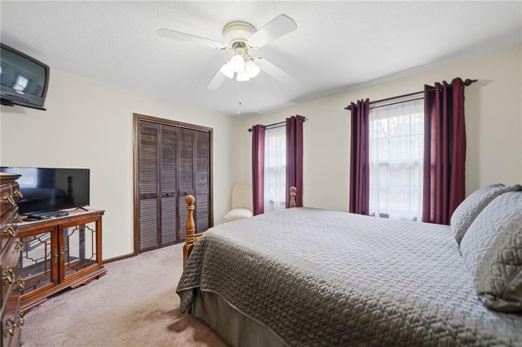 2575 Valleyhill Drive Acworth, GA 30102 - Photo 28 of 48 a bedroom with a bed and a flat screen tv