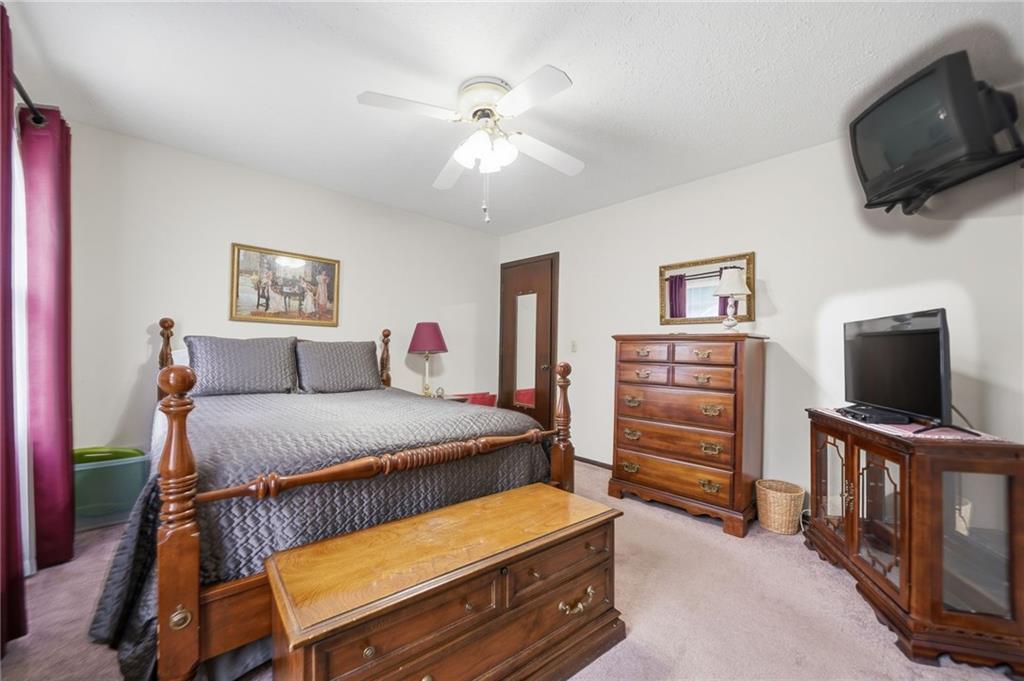 2575 Valleyhill Drive Acworth, GA 30102 - Photo 29 of 48 a bedroom with a bed and flat screen tv