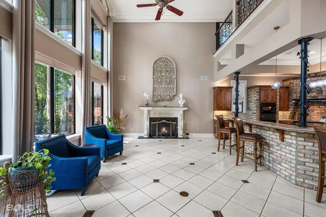 a view of a livingroom with furniture fireplace and windows