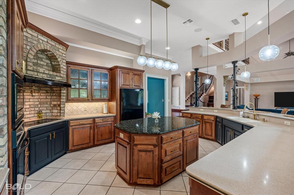 36 Golf Club Drive Haughton, LA 71037 - Photo 14 of 40 a kitchen with stainless steel appliances granite countertop a sink and a stove