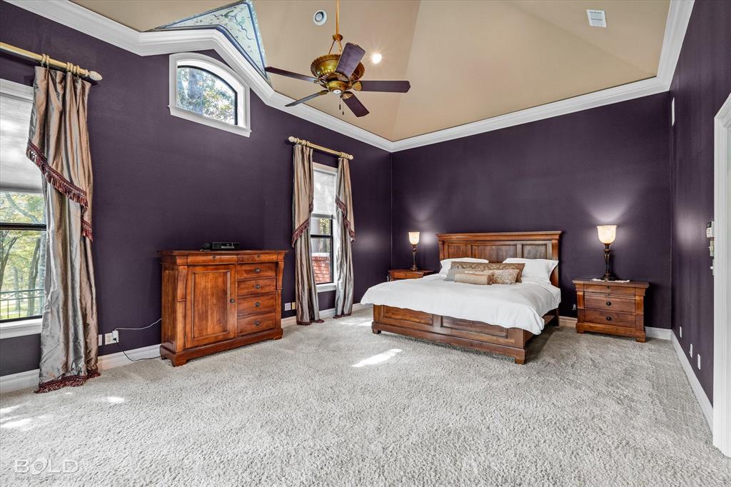 36 Golf Club Drive Haughton, LA 71037 - Photo 16 of 40 a bedroom with a bed and a chandelier