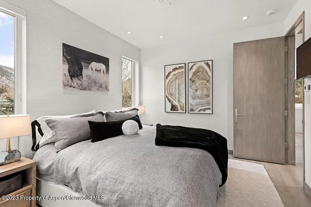 a bed sitting in a bedroom next to a window