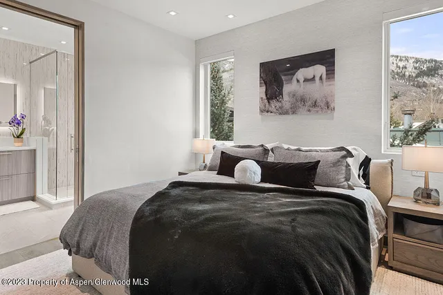 a bathroom with a double vanity sink mirror and shower