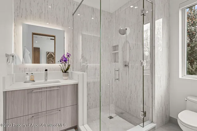 a bedroom with a bed and a mirror