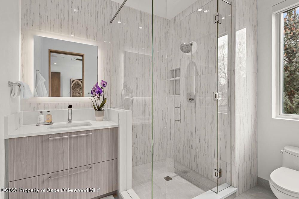 802 East Cooper Avenue, Unit 3 Aspen, CO 81611 - Photo 16 of 28 a bathroom with a double vanity sink mirror and shower