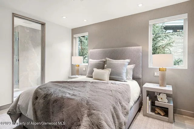 a bathroom with a bathtub shower sink vanity and mirror