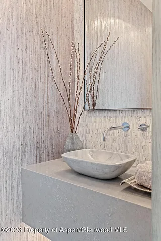 a living room with furniture and a mirror