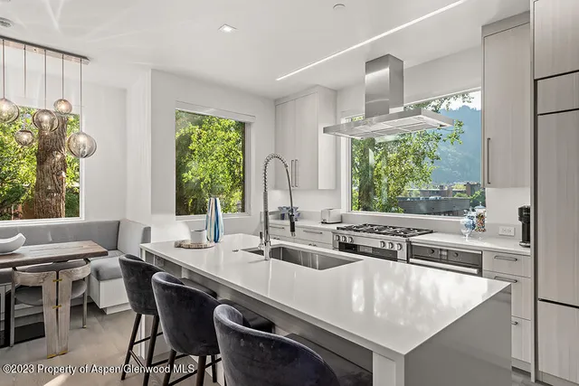 a kitchen with stainless steel appliances granite countertop a sink and a stove
