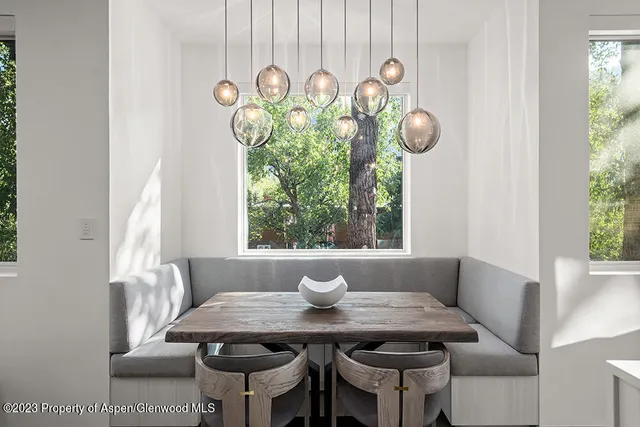 a view of a dining room that has a table and a chair