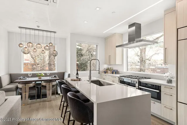 a kitchen with stainless steel appliances a stove a sink and a refrigerator