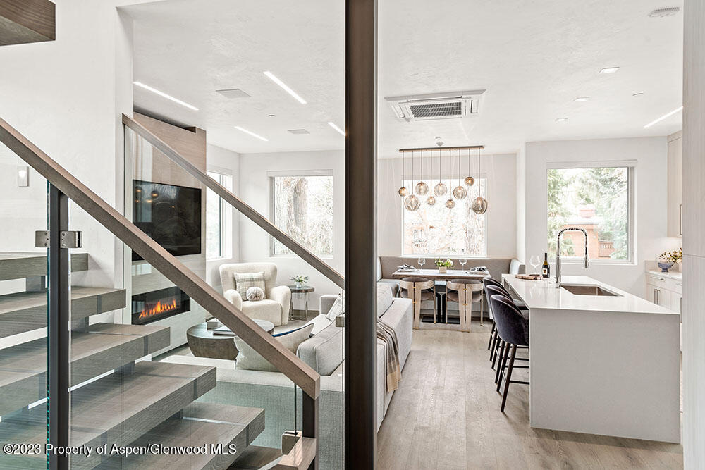 802 East Cooper Avenue, Unit 3 Aspen, CO 81611 - Photo 8 of 28 a view of a dining room with furniture window and wooden floor