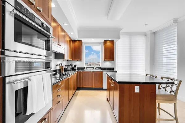 a kitchen with stainless steel appliances granite countertop a stove a sink and a refrigerator