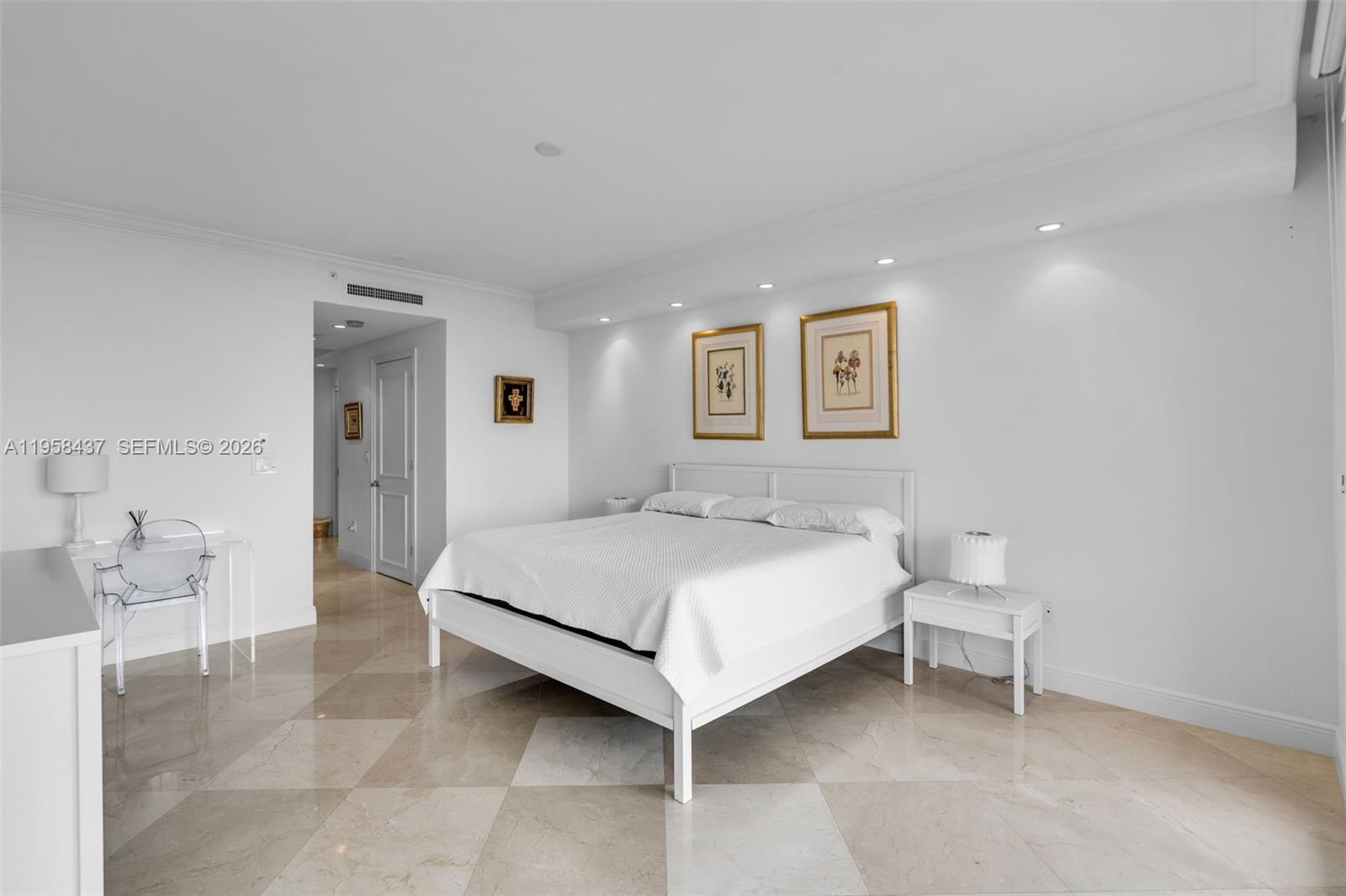 785 Crandon Boulevard, Unit 702 Key Biscayne, FL 33149 - Photo 16 of 41 a bedroom with a bed and a chair