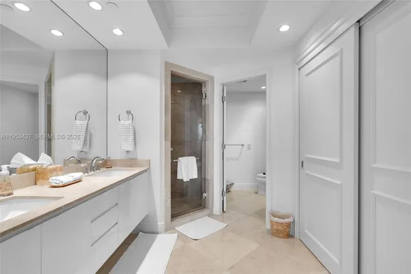 a spacious bathroom with a granite countertop sink mirror and toilet