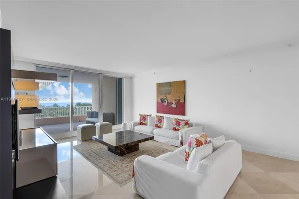 a living room with furniture and a floor to ceiling window