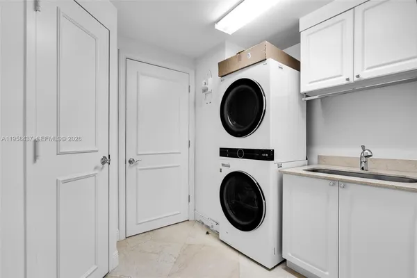 a utility room with sink dryer and washer