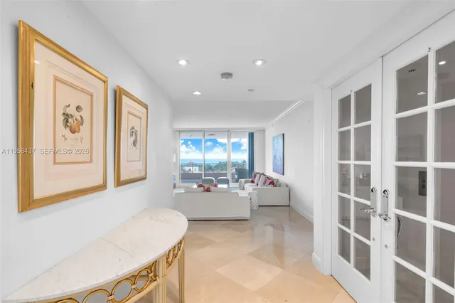 a living room with furniture and large windows