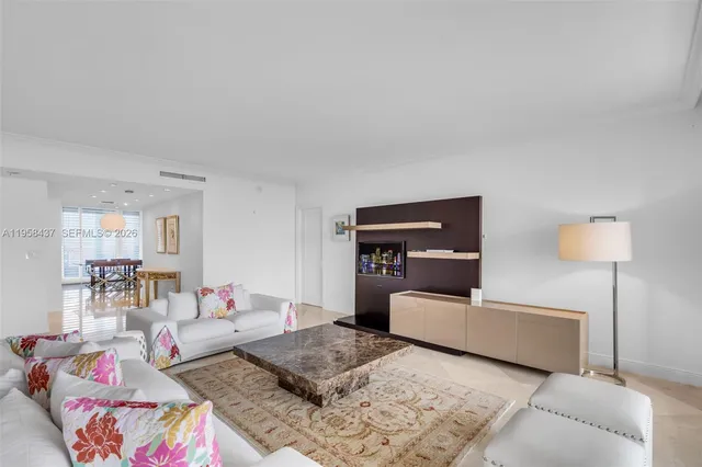 a living room with furniture and a lamp