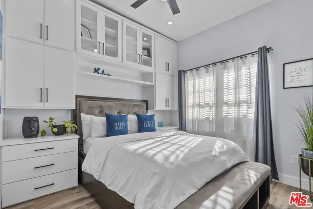 a bedroom with a bed and a flat tv screen