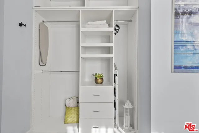 a bedroom with a closet and a shower