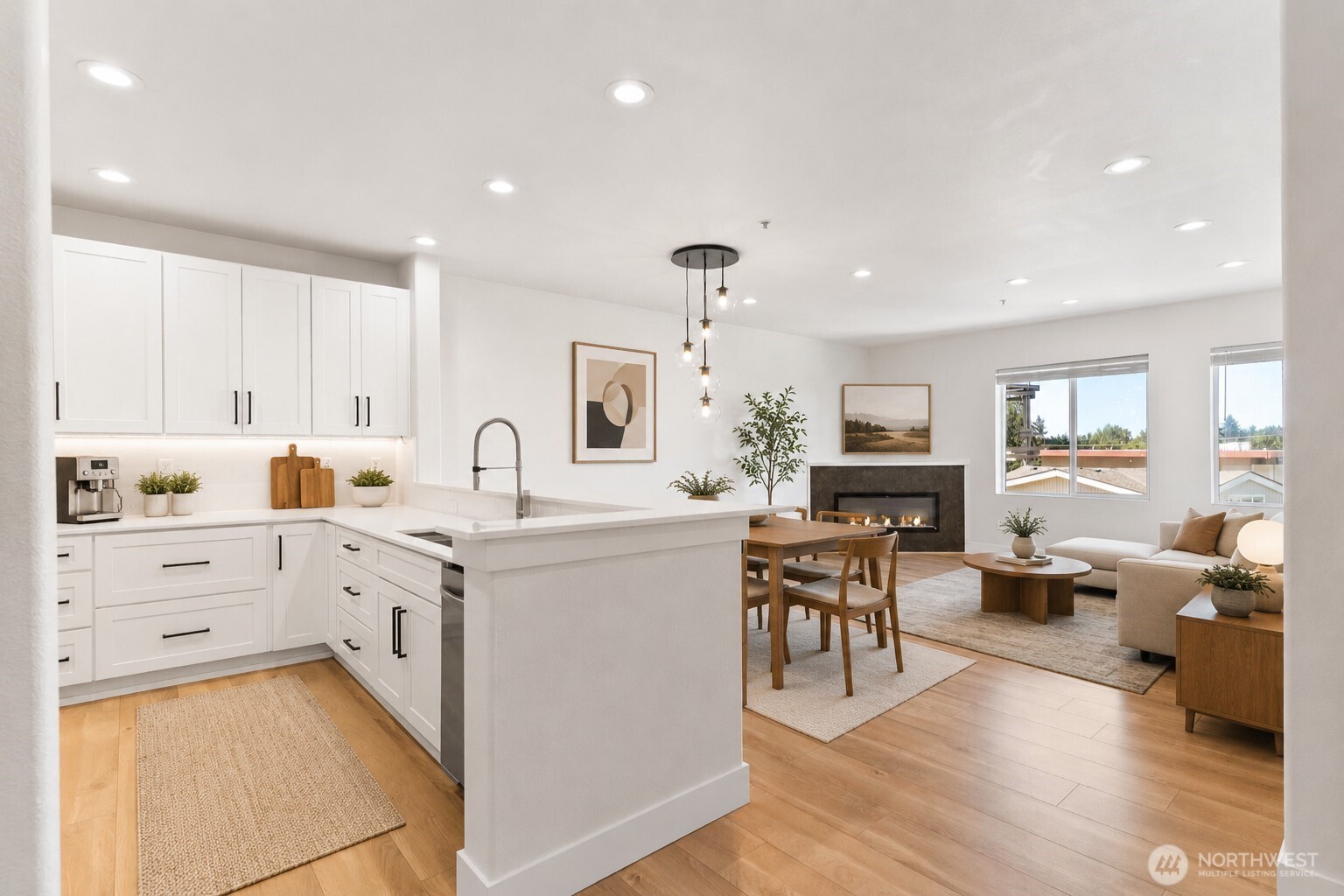 14915 38th Drive Southeast, Unit F3011 Bothell, WA 98012 - Photo 1 of 40 a large white dining hall with stainless steel appliances granite countertop a sink dishwasher a dining table and chairs with wooden floor