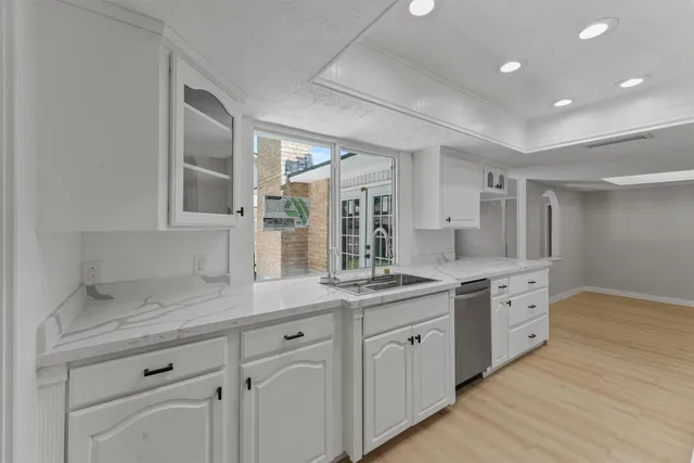 a spacious bathroom with a granite countertop sink mirror and cabinets