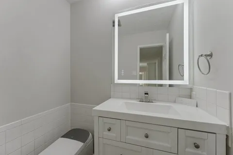 a bathroom with a sink toilet and vanity