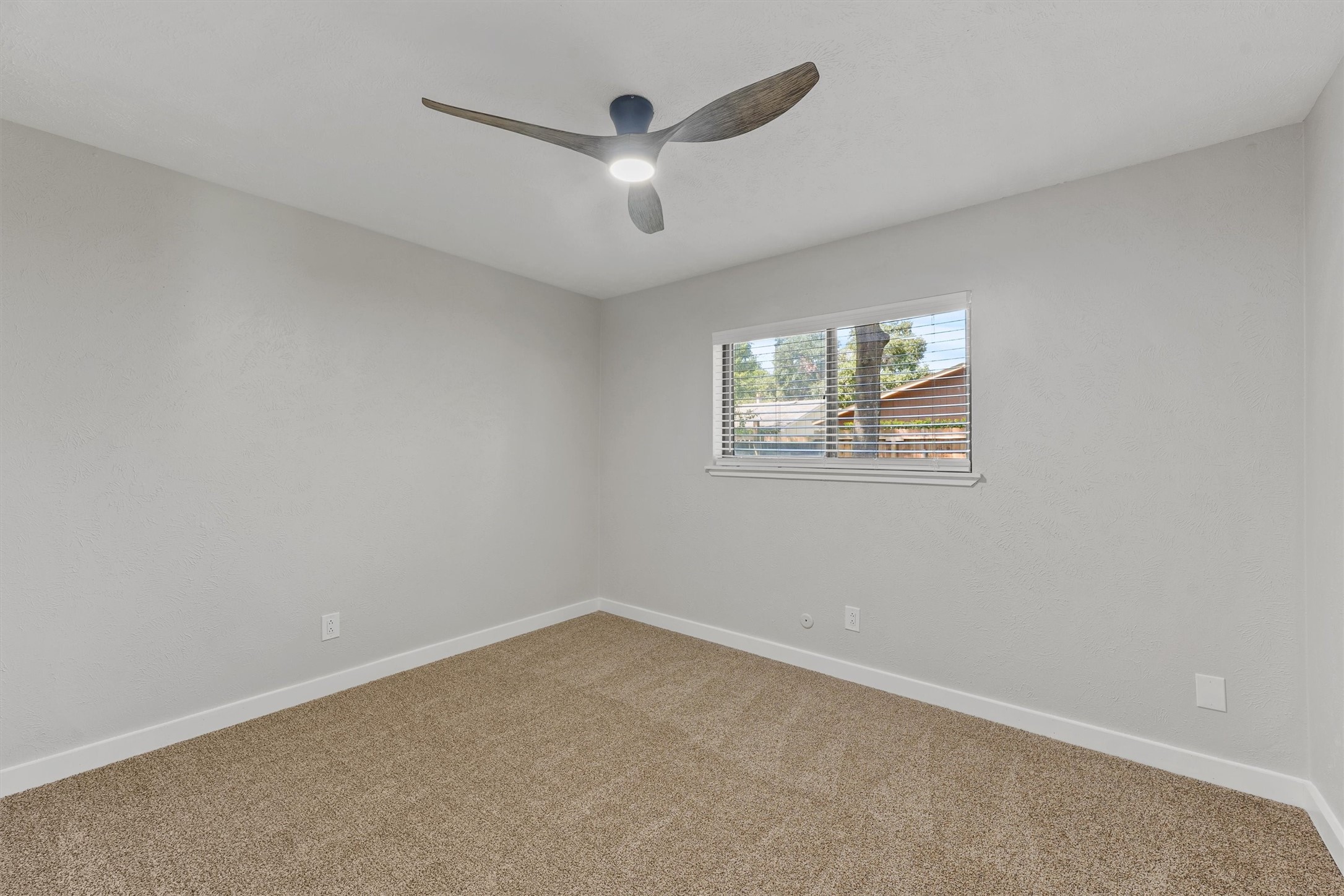 3902 Marywood Drive Spring, TX 77388 - Photo 24 of 29 an empty room with a window and a ceiling fan