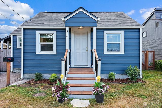 a front view of a house with a garden